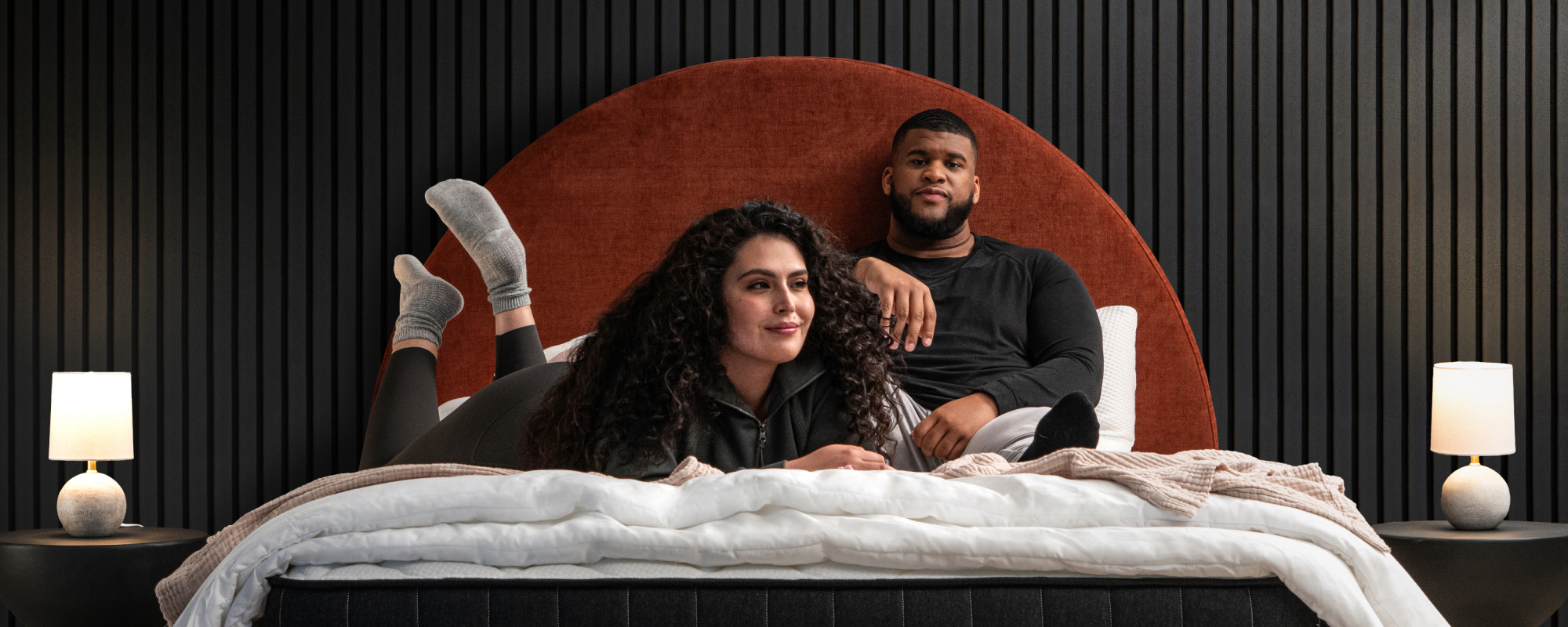 Plus size couple laying on a titan luxe